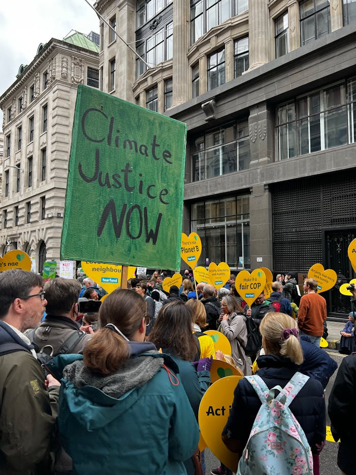 A lively protest advocating for climate justice in a bustling city street.